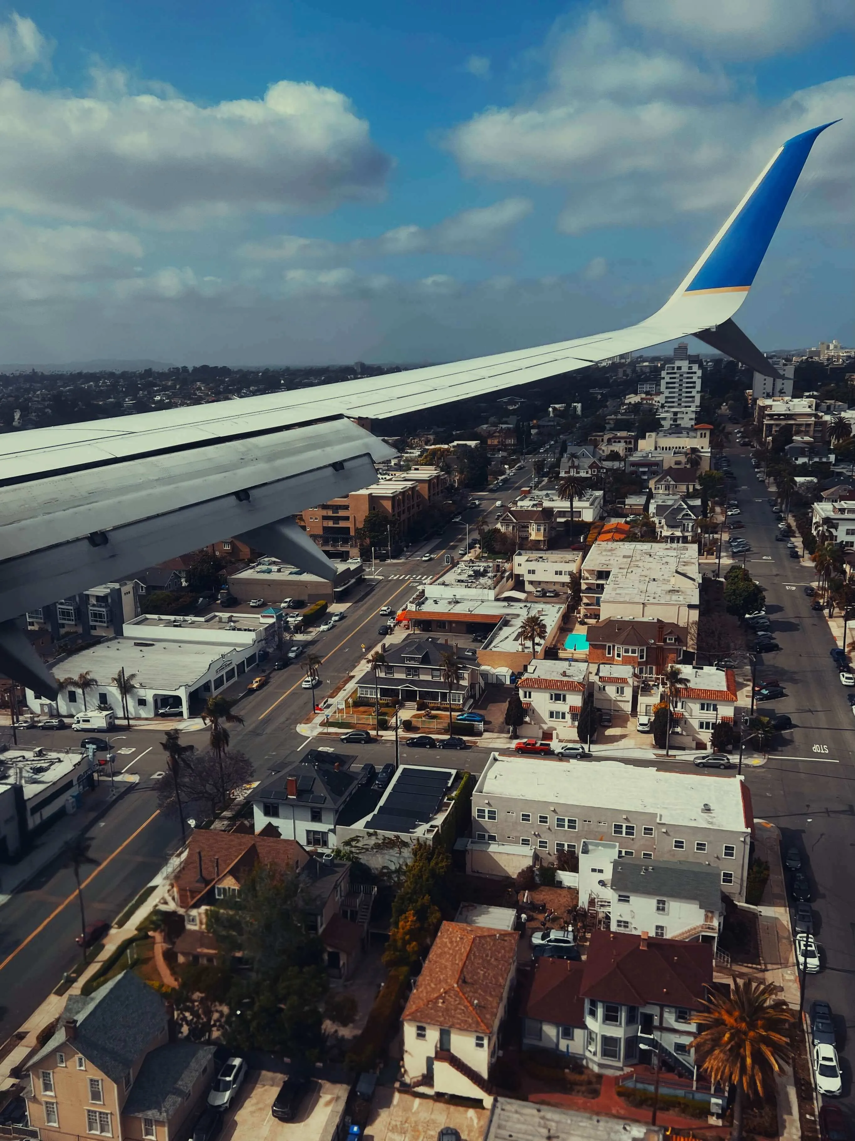 Airplane wing view over residential neighborhoods during approach to san diego
