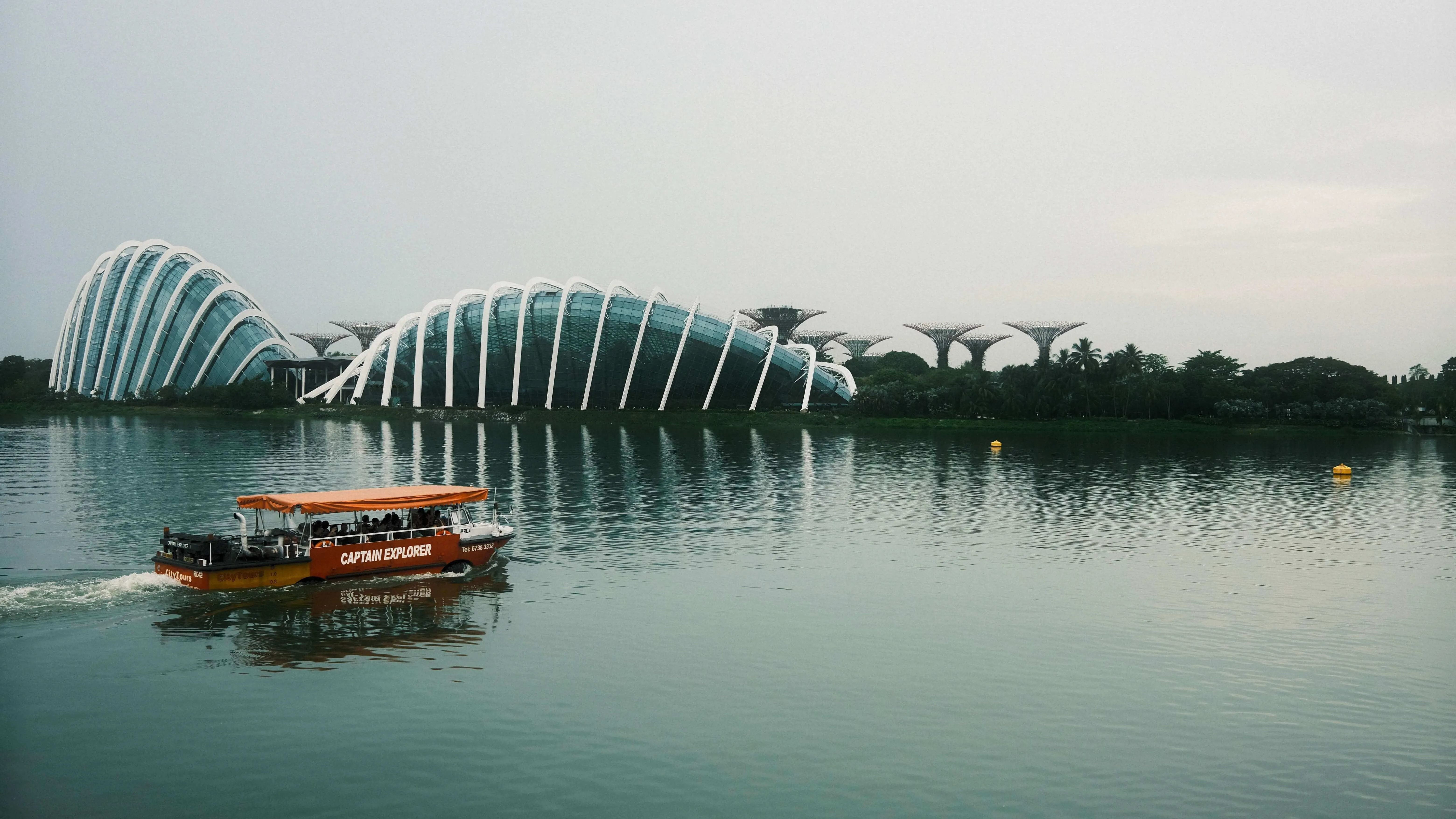 Boat on water with gardens by the bay domes singapore