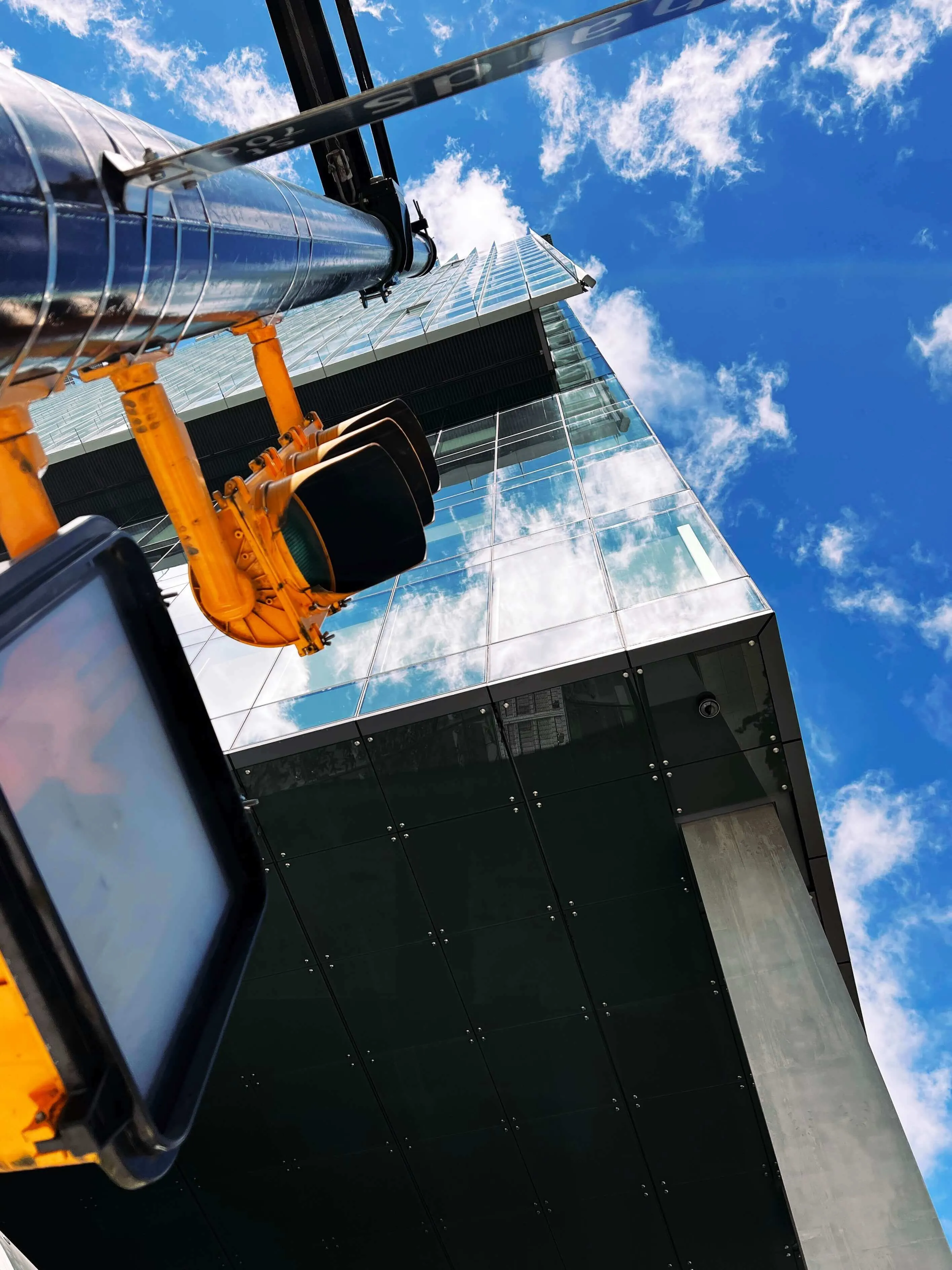 Vancouver downtown skyscraper shot from below with traffic light in foreground
