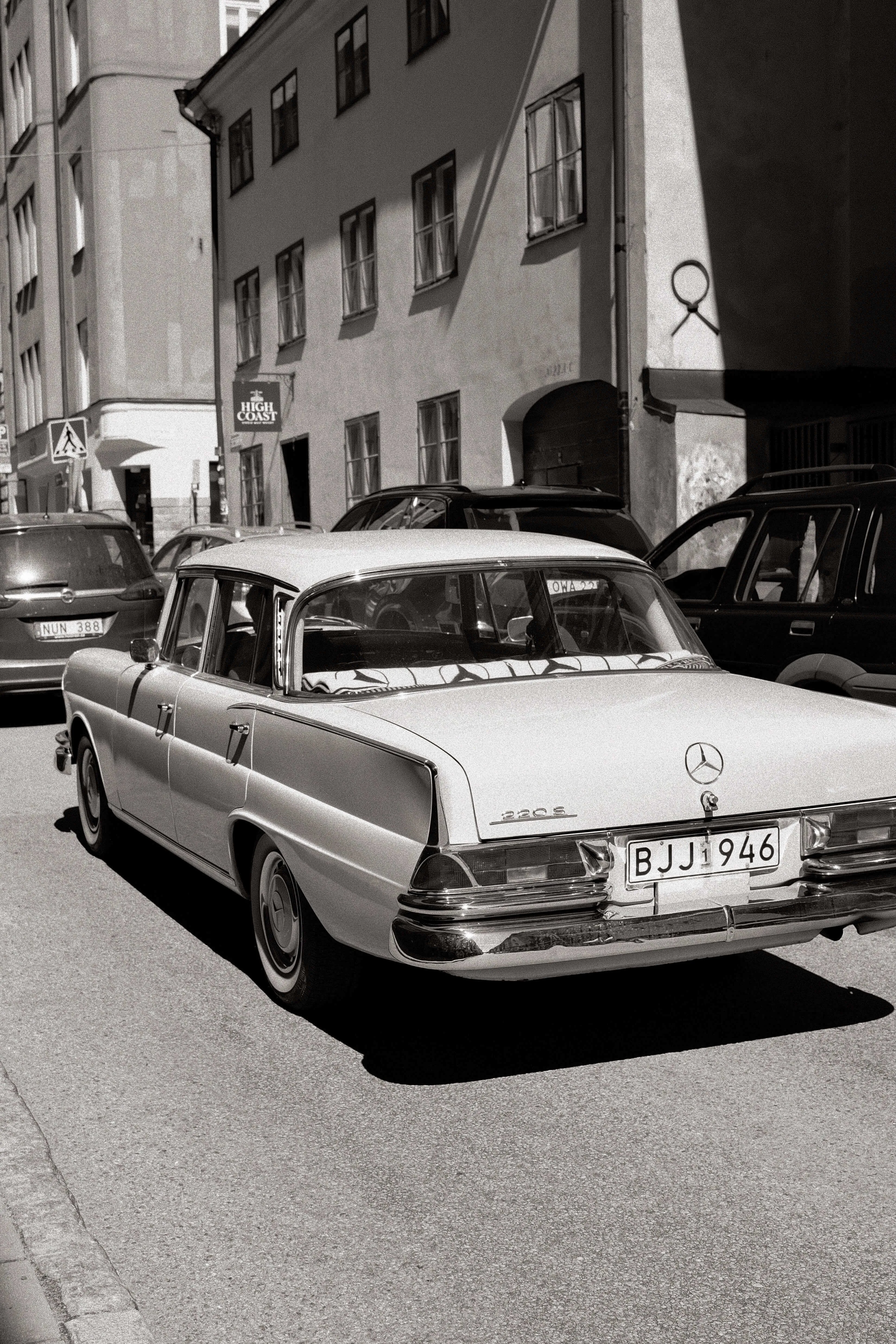 Vintage mercedes parked on narrow street in stockholm black and white