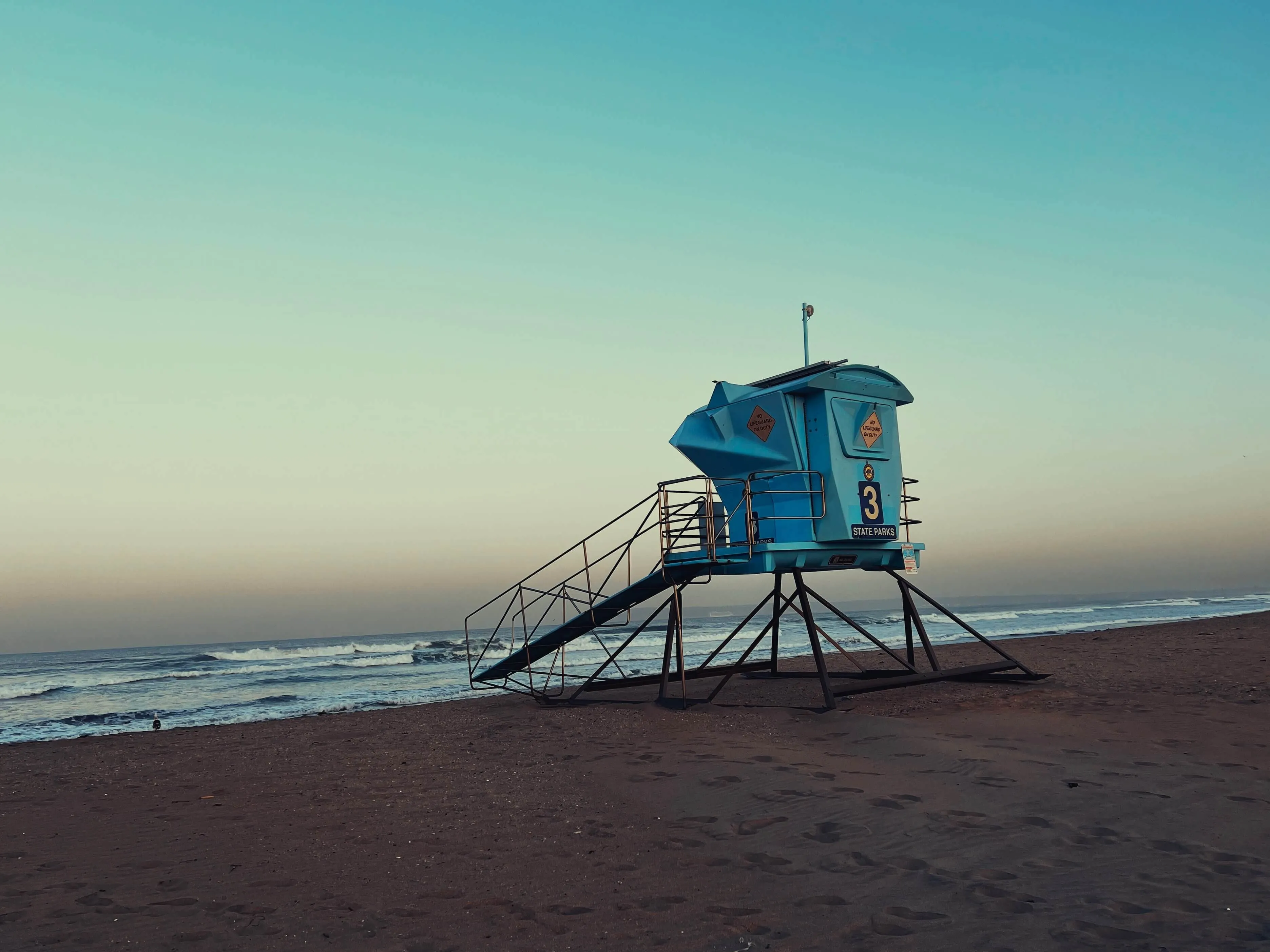 Blue lifeguard tower standing on sand at silver strand state beach san diego