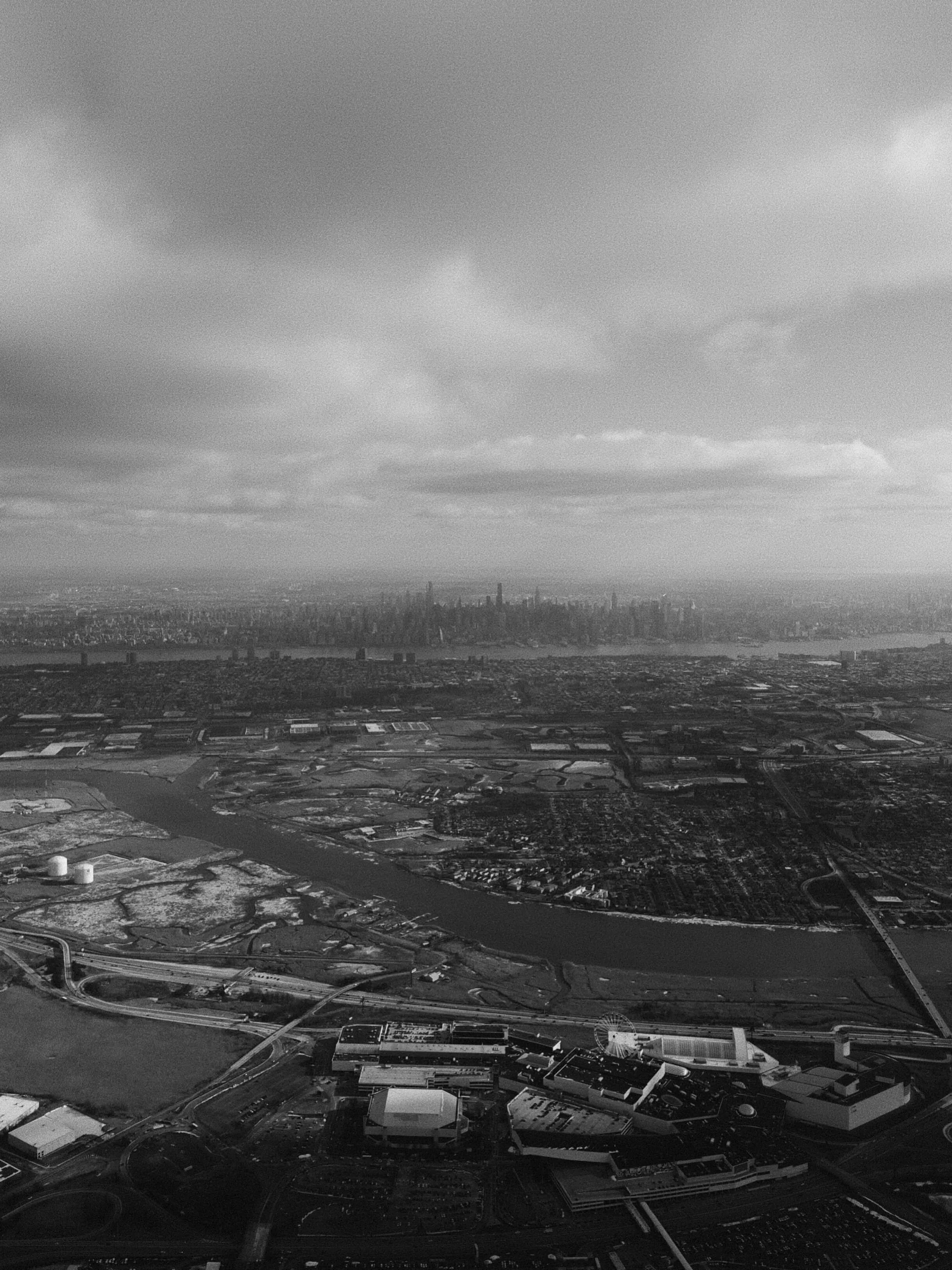 Aerial view of new york city skyline under cloudy sky black and white