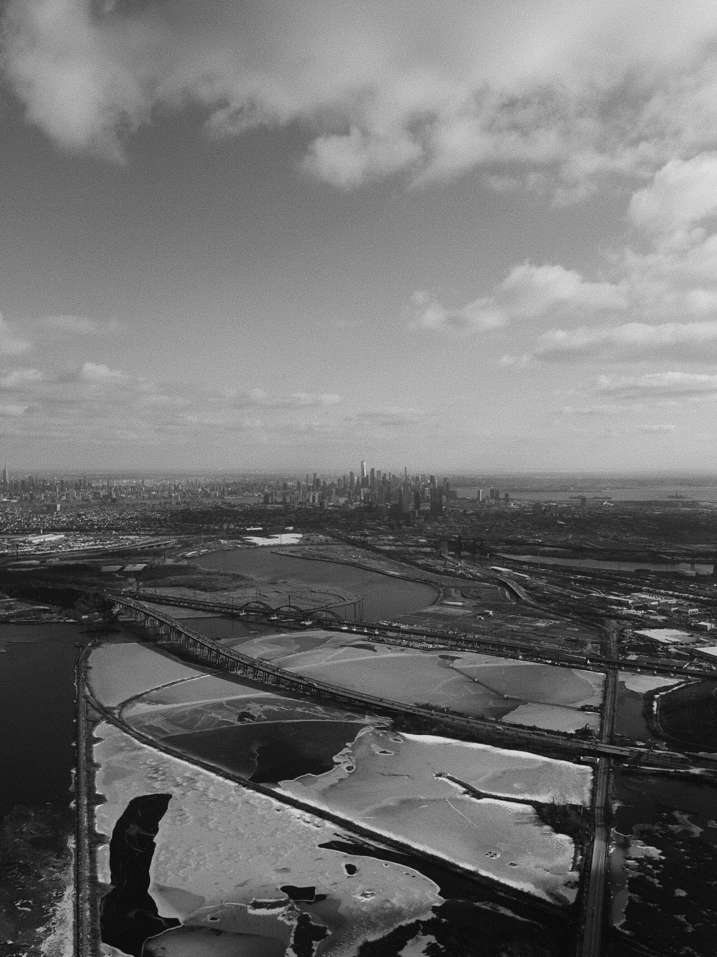 Aerial view of nyc skyline and industrial waterways black and white
