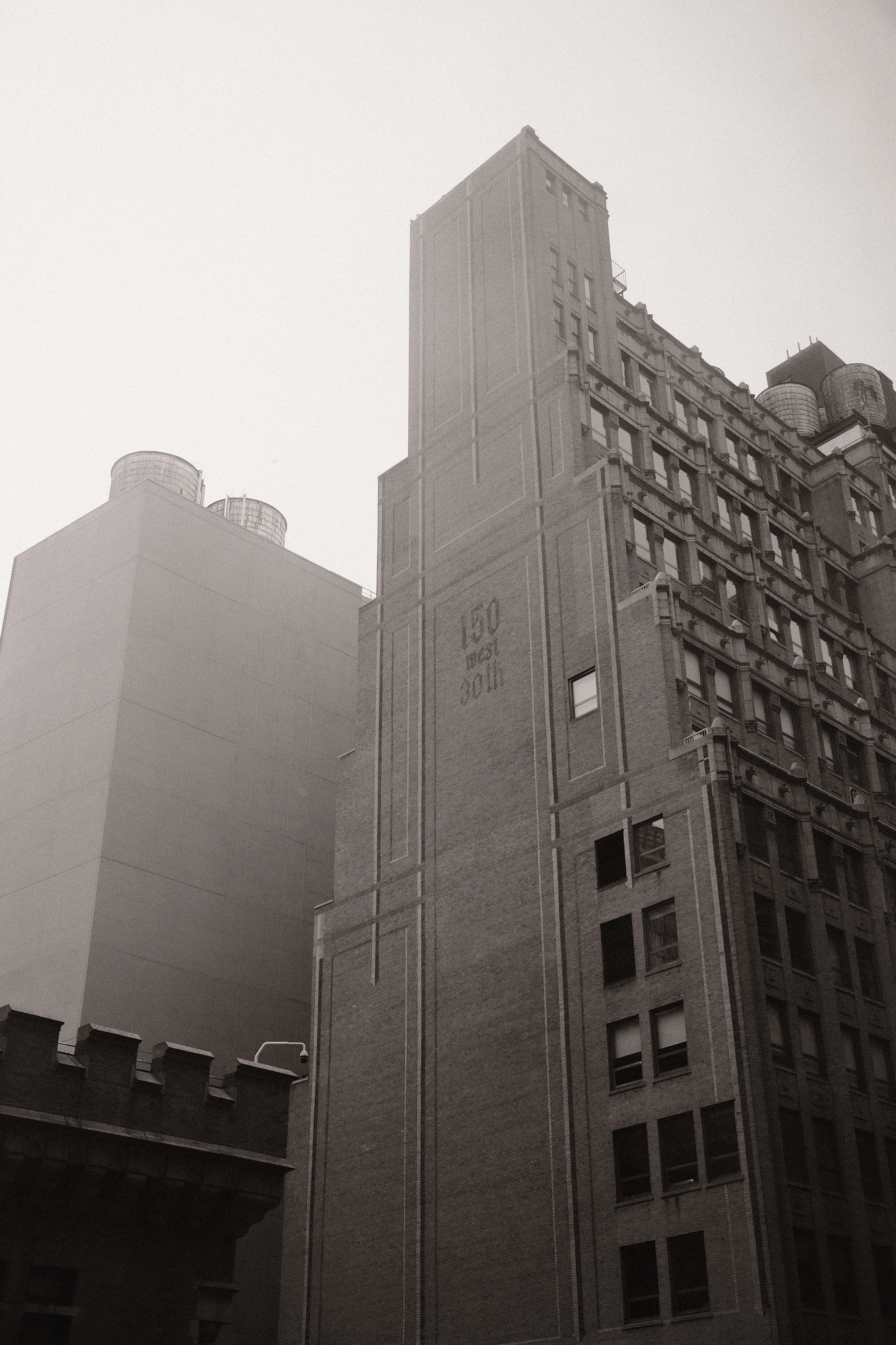 Historic nyc building marked 50 west 30th street black and white